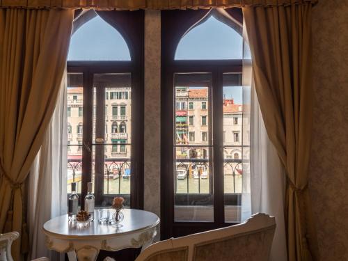 a room with a table in front of a window at EGO' Boutique Hotel - The Silk Road in Venice