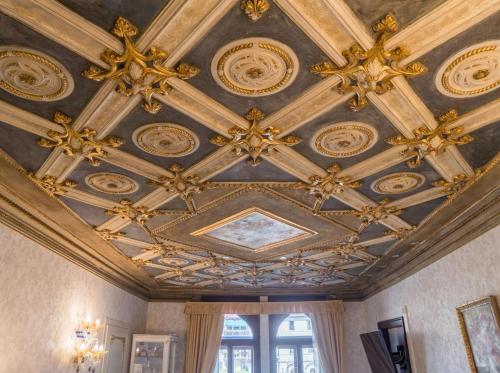 a ceiling in a room with ornate ceilings at EGO' Boutique Hotel - The Silk Road in Venice