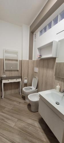 a bathroom with a toilet and a sink at Residenza Lumière in Termoli