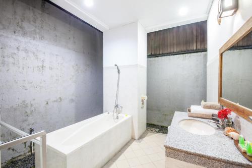 a bathroom with a white tub and a sink at 6-BR Private Pool Legian Villa 5-min Walking to Beach in Seminyak