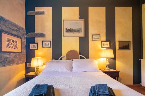 a bedroom with a large bed and two lamps at Casale Giaggiolo in Incisa in Valdarno