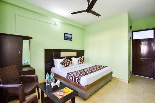 a bedroom with a large bed and a table and a table sidx sidx at Dream Guest House in Dharamshala