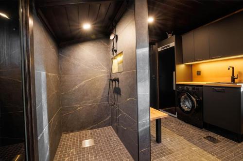 a laundry room with a washer and dryer at Cottage Finland- Levin Hehku B in Levi