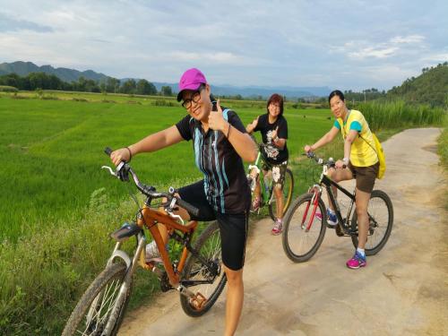 a group of people riding bikes on a dirt road at Cat Tien Jungle Lodge in Cat Tien