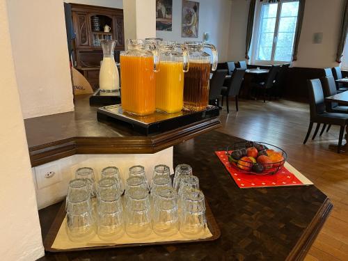 a group of glasses sitting on a counter with drinks at Hotel Drei Könige in Chur