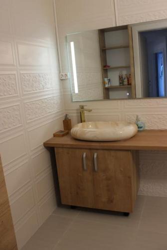 a bathroom with a sink and a mirror at House in Brasov in Săcele