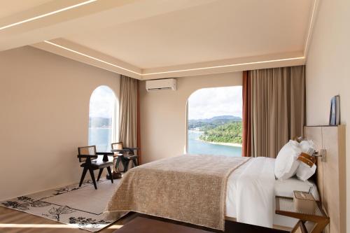 a hotel room with a large bed and a large window at 阿卡那拉橘子海亲子民宿 in Dapeng