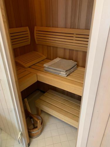 a sauna with wooden shelves and a book at Garmisch Lux Apartment mit Sauna in Garmisch-Partenkirchen