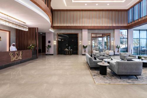 a lobby with couches and chairs in a building at Warwick Al Jubail Hotel in Al Jubail
