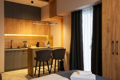 a kitchen with a table and chairs in a room at Nest Suites in Skopje