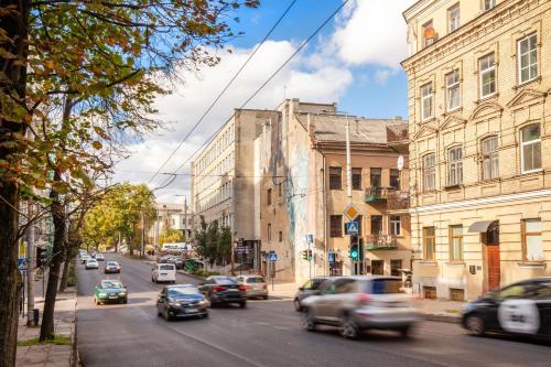 a busy city street with cars driving down the street at Hook Studios Vilnius Old Town in Vilnius