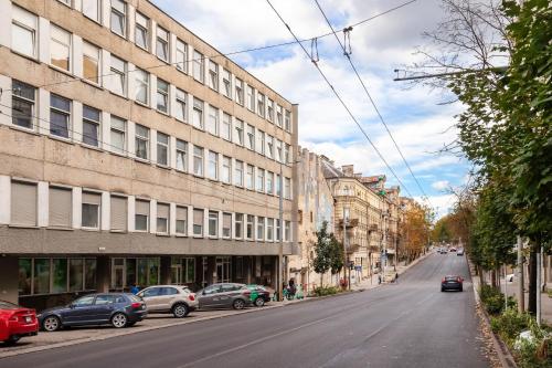 an empty street with cars parked on the side of a building at Hook Studios Vilnius Old Town in Vilnius