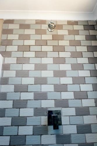 a tiled floor with a camera in a bathroom at STAY In TEHAMA in Cape Town