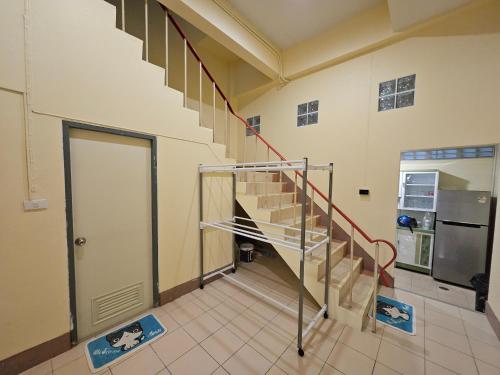 a spiral staircase in a room with a refrigerator at My Home Central Hatyai - Whole house - 18pax in Sathani Khlong Rian