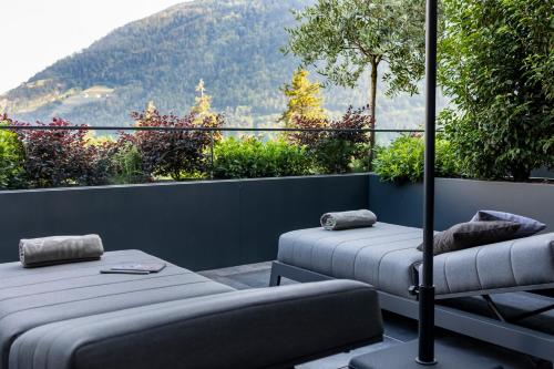 two beds on a balcony with a view of a mountain at Avidea - Adults Only in Lagundo