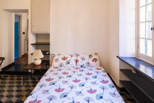 a bedroom with a bed with a colorful bedspread at Case Schiaffino by Wonderful Italy in Laigueglia