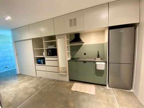 a large kitchen with white cabinets and a refrigerator at Mountain View Villa - Heated Big Pool-Quinta da BellaVista in Santarém