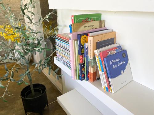 a pile of books sitting on a shelf at Mountain View Villa - Heated Big Pool-Quinta da BellaVista in Santarém