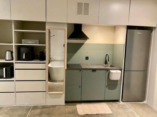 a small kitchen with white cabinets and a sink at Mountain View Villa - Heated Big Pool-Quinta da BellaVista in Santarém