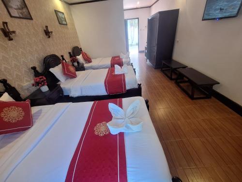 Ένα ή περισσότερα κρεβάτια σε δωμάτιο στο Luang Prabang Pavilion Hotel & Travel