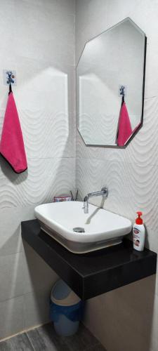 a bathroom with a sink and a mirror at 2 BR Apartment Grand Jati Junction Medan view City 12th Floor in Medan