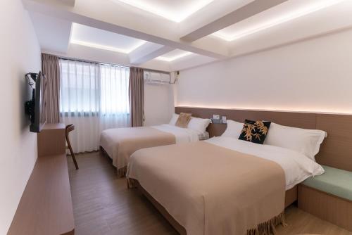 Postel nebo postele na pokoji v ubytování Xiamen Bashi Living Room B&B 厦门八适客厅民宿