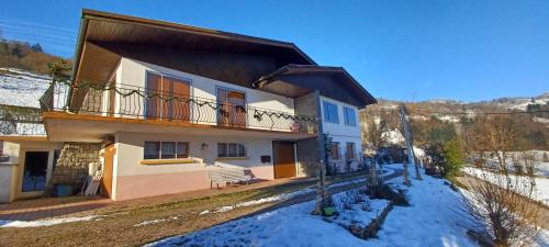 a house with a balcony in the snow at La colline de pam in Cornimont