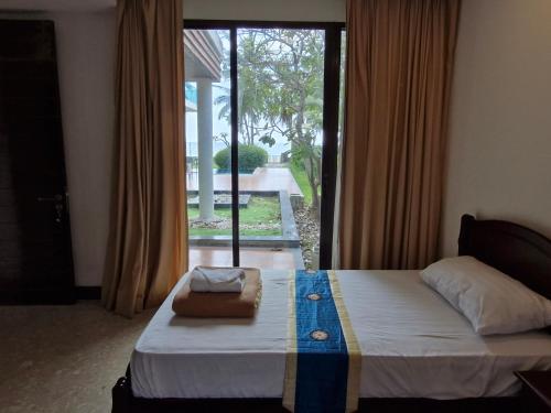 Postel nebo postele na pokoji v ubytování Palmeraiebeach Resort Rayong ปาล์มมาลี บีช รีสอร์ท ระยอง 罗勇棕榈树海滩酒店