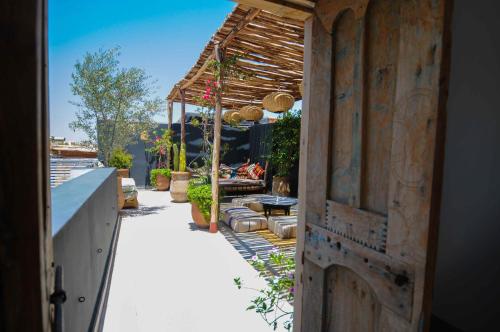 an open door to a patio with a pergola at Riad Origines in Marrakech