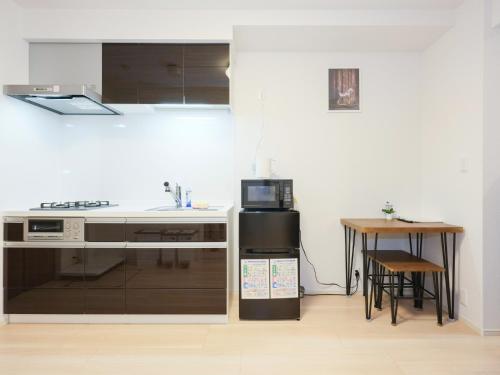 a kitchen with a sink and a stove top oven at Shinjuku Tokyo Holiday Hotel in Tokyo
