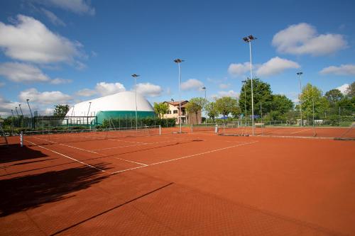 a tennis court with a domed building and a tennis court at Ancora Sport Resort Hotel in Meolo