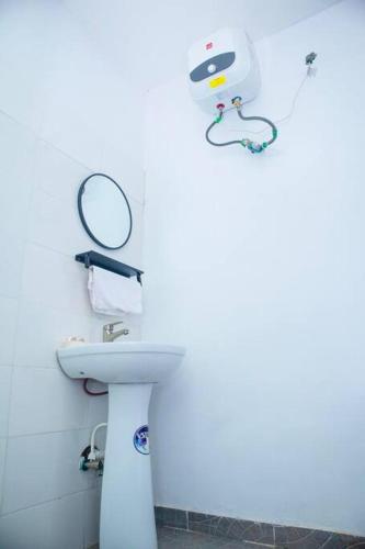 a bathroom with a sink and a mirror on the wall at Minimalist Haven King Bed 247 Power Security in Sangotedo