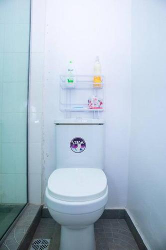 a bathroom with a white toilet in a room at Minimalist Haven King Bed 247 Power Security in Sangotedo