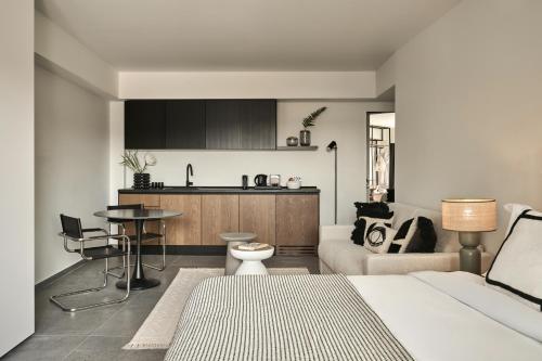 a living room with a bed and a kitchen at Vision Gazi in Athens