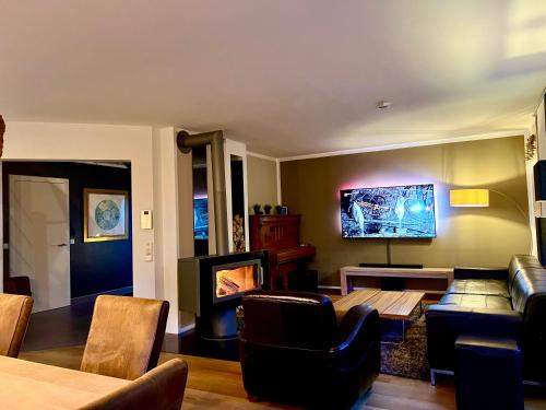a living room with a couch and a table at Ferienhaus Celeste in Warnemünde