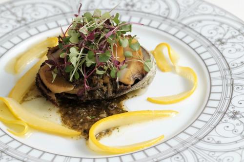 a white plate with a piece of food on it at HOTEL de L'ALPAGE in Chino