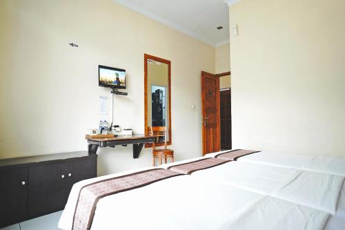 Postel nebo postele na pokoji v ubytování Saung Balibu Hotel