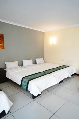Postel nebo postele na pokoji v ubytování Saung Balibu Hotel