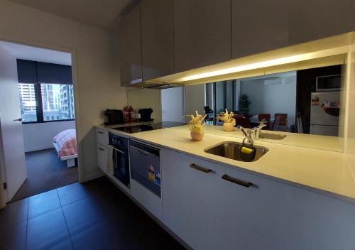 a kitchen with a sink and a counter top at Melbourne Single family apartment 2Br 2Bth Indoor Pool Sauna in Melbourne