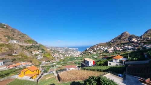a view of a village on a mountain at Varandas da Caldeira by Madeira ReAL in Câmara de Lobos