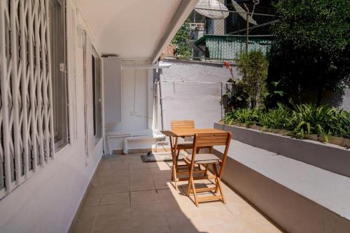 a wooden table and two chairs sitting on a balcony at Modern and Designed 2BR W Garden in Adalar