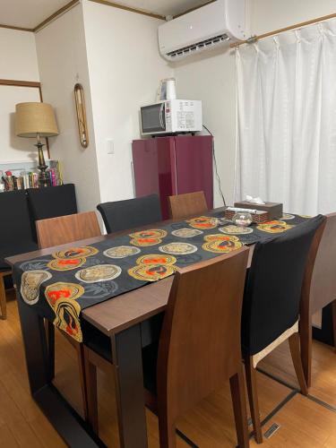 a dining room table with a table cloth on it at Share House on the Hill in Yokohama