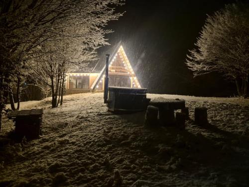 a playground in a snow covered field at night at Cabana Pietrusa in Cavnic