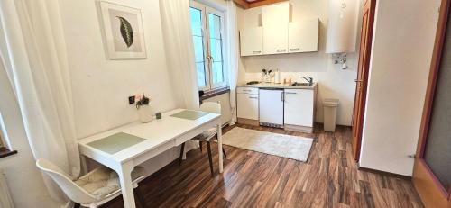 a small kitchen with a white desk in a room at Hochkogelhaus - flying oasis, Hohe Wand in Maiersdorf