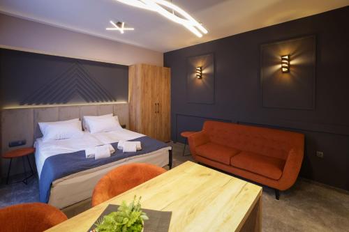 a hotel room with a bed and a table at Nest Suites in Skopje