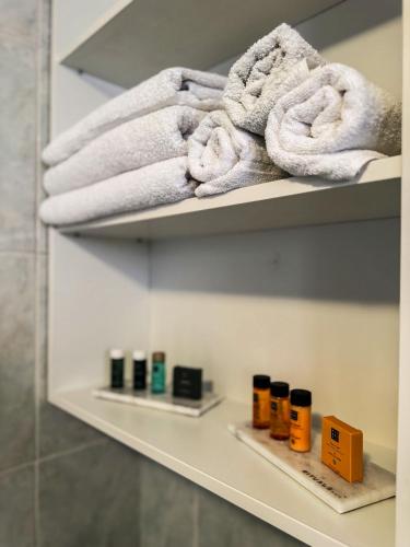 a shelf with towels on it in a bathroom at Ozone Home in Cluj-Napoca