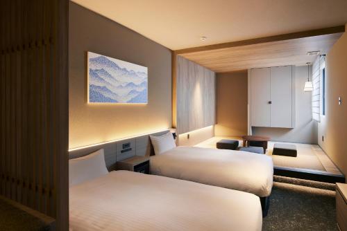 a hotel room with two beds and a window at Minn Asakusa Kuramae Station in Tokyo