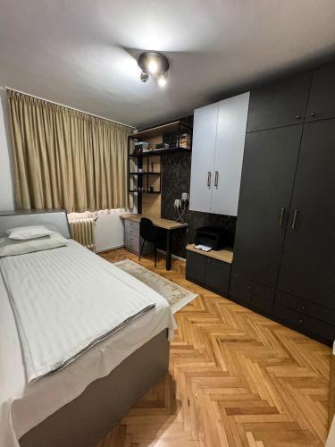 a bedroom with a bed and a desk in it at Ozone Home in Cluj-Napoca