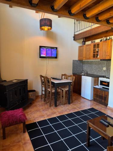 a kitchen and dining room with a table and chairs at Frigias 1 in Arachova