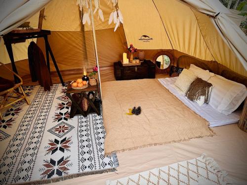 an interior view of a tent with a table in it at Zenda Glamping in Bao Loc